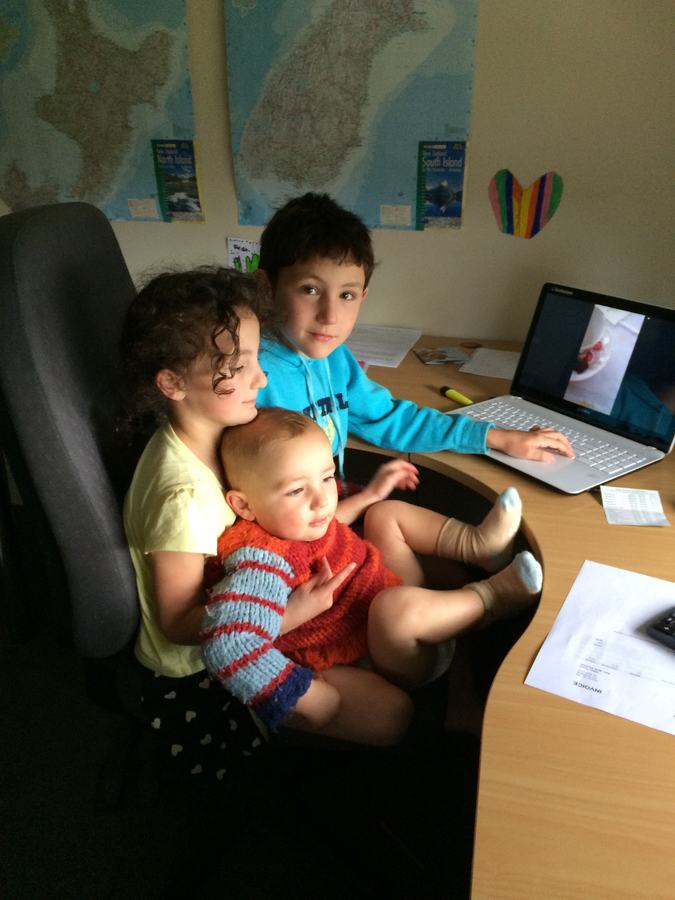 Children watching something together on a laptop