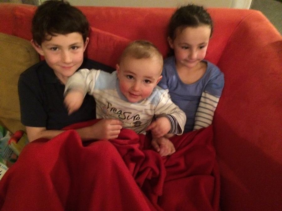 Three children together on the sofa
