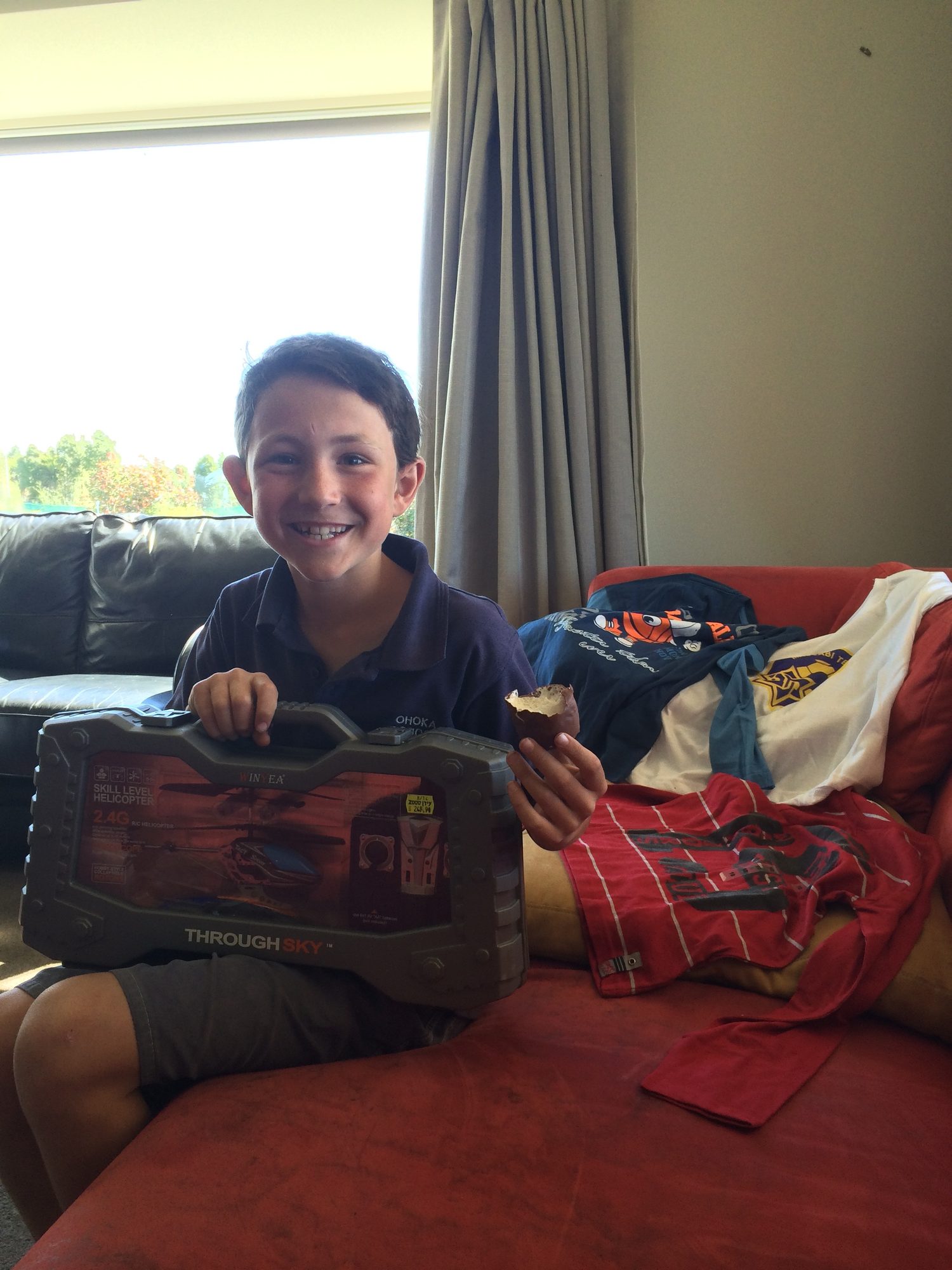 Boy on the sofa with his school bag