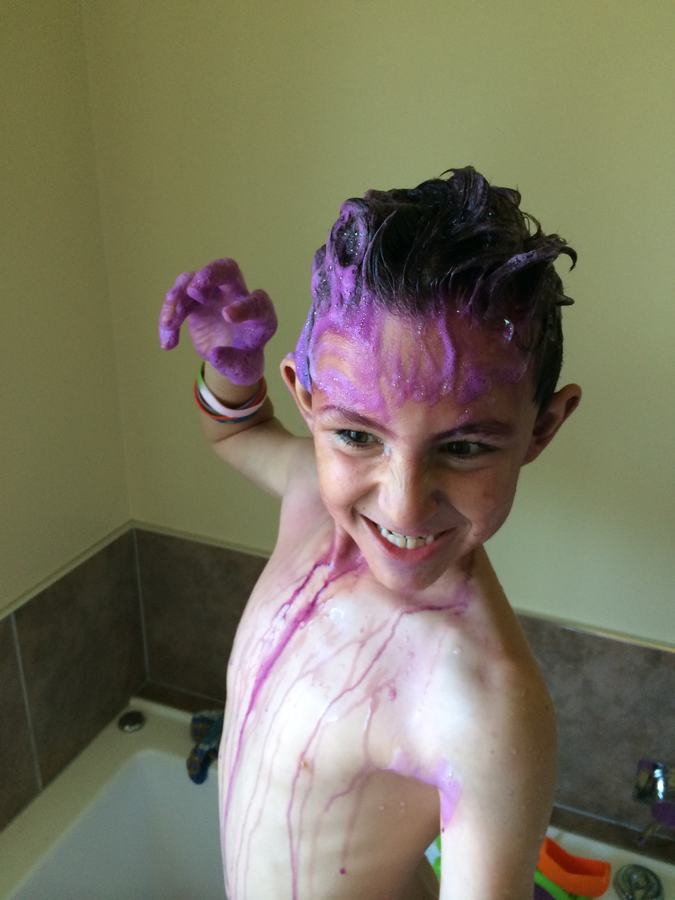 Boy covered in purple paint, hair spiked up