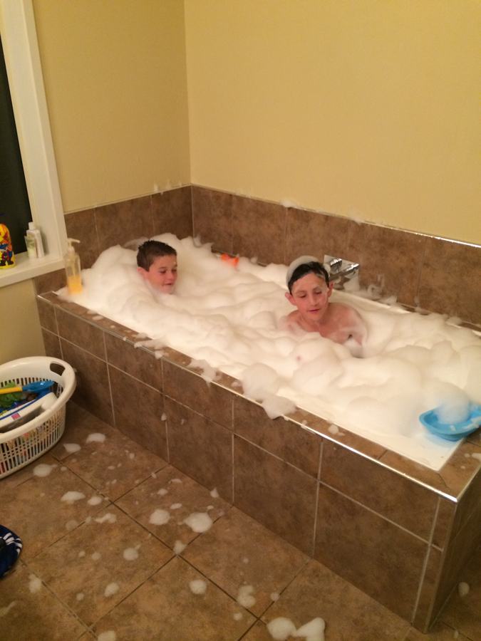 Boy relaxing in a bubble bath
